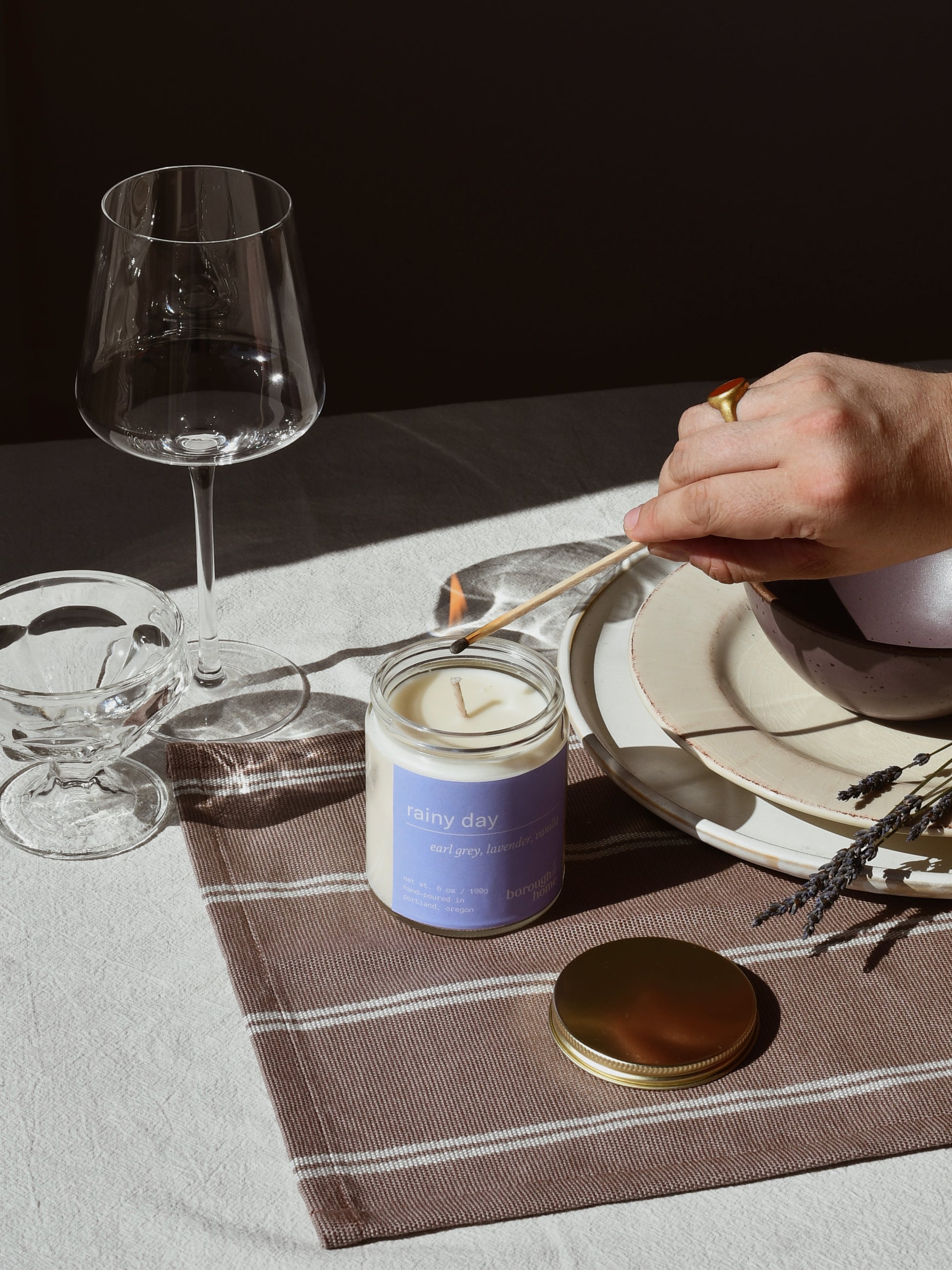 Rainy Day candle with various tableware, top down view.