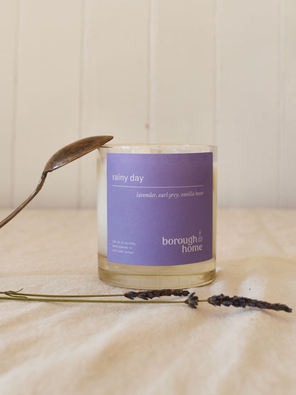 Rainy Day candle with lavender bud and spoon, front view.